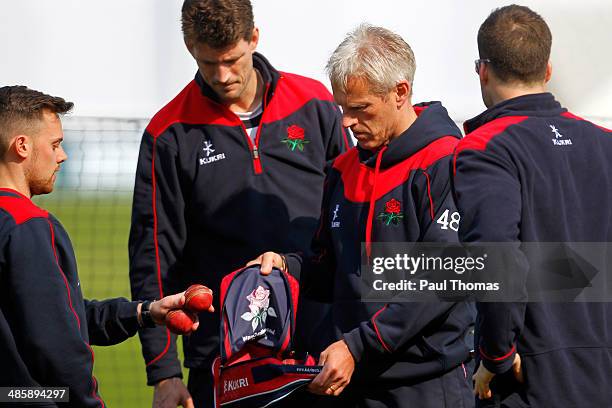 Head coach Peter Moores of Lancashire collects cricket balls before the LV County Championship match between Lancashire and Warwickshire at Old...