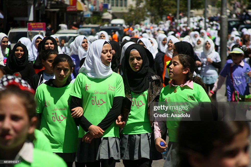 Palestinian students march in Hebron