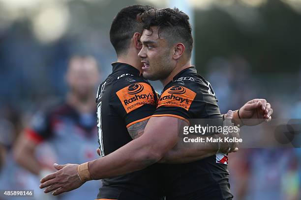 Dene Halatau and David Nofoaluma of the Wests Tigers celebrate after David Nofoaluma scored a try during the round 25 NRL match between the Wests...