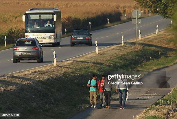 Group of migrants from Afghanistan and Pakistan walks along a country road shortly after they crossed from Austria into Germany on August 30, 2015...