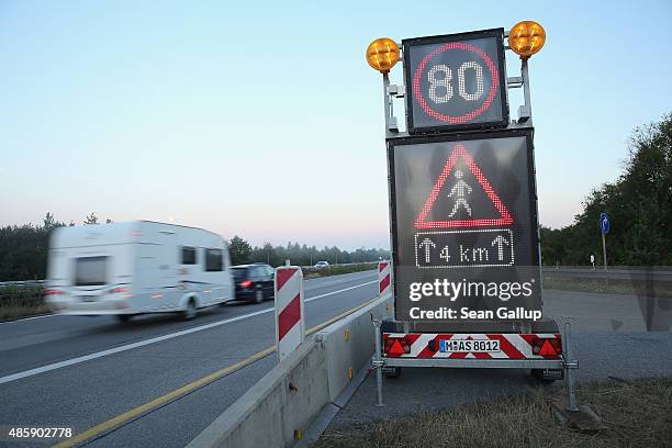 Sign warns of pedestrians on the A3 highway near the border to Austria on a section used daily by arriving migrants on August 30, 2015 near Neuhaus...