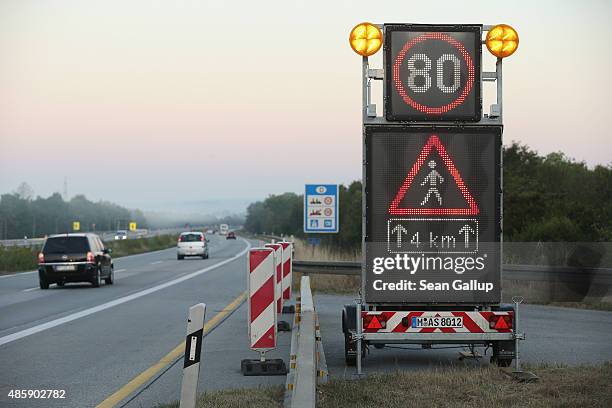 Sign warns of pedestrians on the A3 highway near the border to Austria on a section used daily by arriving migrants on August 30, 2015 near Neuhaus...