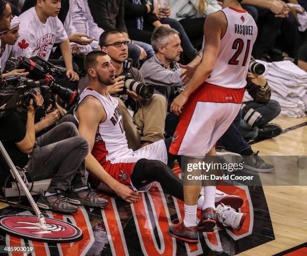 Toronto Star photographer Steve Russell and Canadian Press Photographer Chris Young wait for Toronto Raptors guard Greivis Vasquez to help team mate...