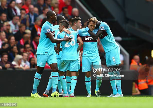 Mark Noble of West Ham United is congratulated on his goal during the Barclays Premier League match between Liverpool and West Ham United at Anfield...