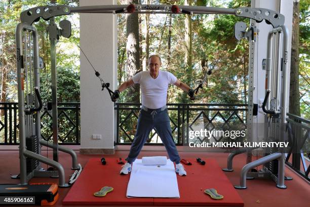 Russias President Vladimir Putin works out at a gym at the Bocharov Ruchei state residence in Sochi on August 30, 2015. AFP PHOTO / RIA NOVOSTI /...