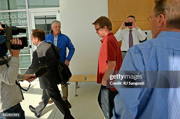 Lance Kirk, center, walks past media after an advisement hearing in Denver District Court, for his brother, Richard Kirk, April 21, 2014. Richard...