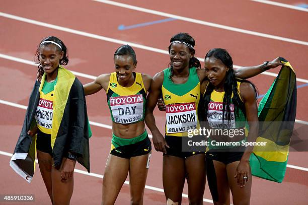 Shericka Jackson of Jamaica, Stephenie Ann McPherson of Jamaica, Novlene Williams-Mills of Jamaica and Christine Day of Jamaica celebrate after...