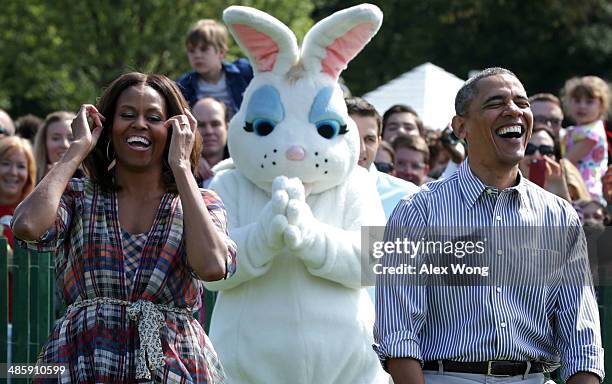 President Barack Obama and first lady Michelle Obama rejoice as they watch children participate in the annual White House Easter Egg Roll on the...