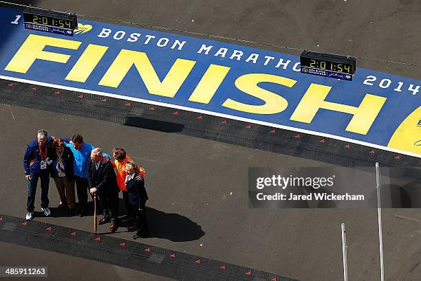 Former Boston mayor, Thomas Menino , current Boston mayor Marty Walsh , and Grand Marshal Bill Rodgers pose for a photo after crossing the finish...