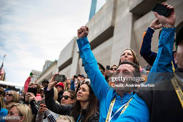 People cheer as Meb Keflezighi, an American, wins the Boston Marathon on April 21, 2014 in Boston, Massachusetts. Today marks the 118th Boston...