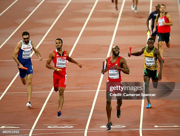 Lashawn Merritt of the United States crosses the line to win gold ahead of Martyn Rooney of Great Britain, Machel Cedenio of Trinidad and Tobago and...