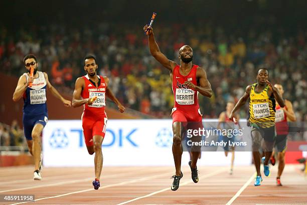 Lashawn Merritt of the United States crosses the line to win gold ahead of Martyn Rooney of Great Britain, Machel Cedenio of Trinidad and Tobago and...