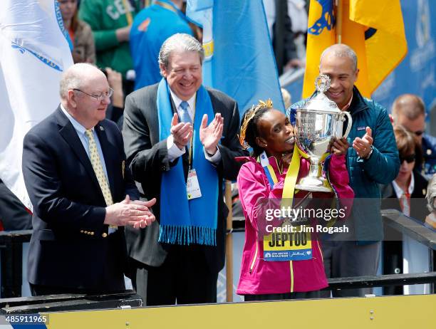 Rita Jeptoo of Kenya celebrates with the trophy after winning the 118th Boston Marathon on April 21, 2014 in Boston, Massachusetts.