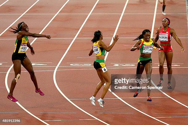 Shericka Jackson of Jamaica, Novlene Williams-Mills of Jamaica and Christine Day of Jamaica celebrate after winning gold in the Women's 4x400 Relay...