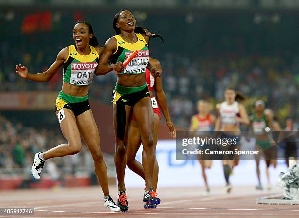 Novlene Williams-Mills of Jamaica and Christine Day of Jamaica celebrate after winning gold in the Women's 4x400 Relay Final during day nine of the...