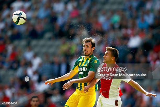 Mike Havenaar of ADO Den Haag challenges for the headed ball with Joel Veltman of Ajax during the Dutch Eredivisie match between Ajax Amsterdam and...