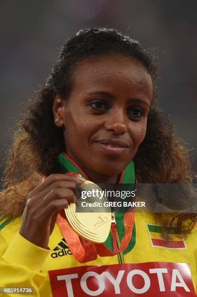 Gold medallist Ethiopia's Mare Dibaba shows off her medal on the podium during the victory ceremony for the women's marathon athletics event at the...