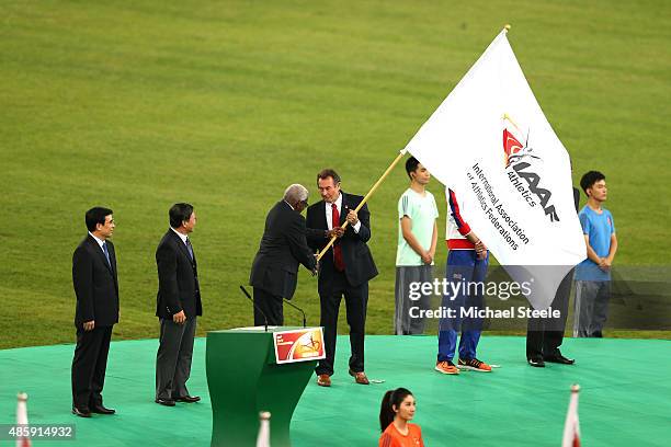 President Lamine Diack hands over the IAAF flag to President of UK athletics Lynn Davies during the closing ceremony during day nine of the 15th IAAF...