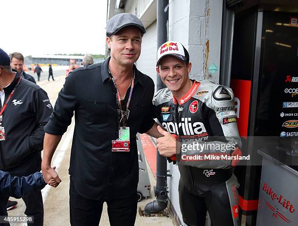 Brad Pitt and Stefan Bradl attend the MotoGP British Grand Prix race at Silverstone ahead of the release of documentary Hitting The Apex. Pitt is...