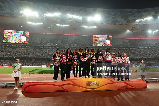Silver medallists USA's Sanya Richards-Ross, Francena McCorory, Natasha Hastings, Allyson Felix, gold medallsits Jamaca's Christine Day, Shericka...
