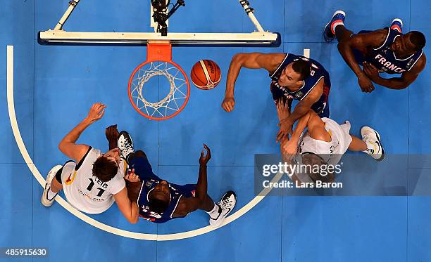 Mickael Gelabale of France challenges Dirk Nowitzki of Germany during the Men's Basketball friendly match between Germany and France at Lanxess Arena...