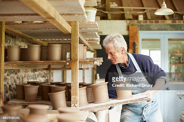 Potter moving boards of pots