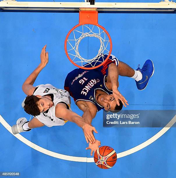 Tibor Pleiss of Germany challenges Rudy Gobert of France during the Men's Basketball friendly match between Germany and France at Lanxess Arena on...