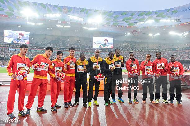 Silver medalists Team China, gold medalists Team Jamaica and bronze medalists Team Canada pose on the podium during the medal ceremony for the Men's...