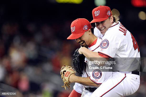 Casey Janssen of the Washington Nationals celebrates with Anthony Rendon in the seventh inning after Rendon recorded the final out in the inning...