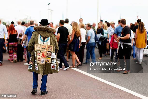 Mod takes a stroll on the promenade during the Brighton Mod Weekender where mods and their scooters gather on the annual bank holiday weekend event...