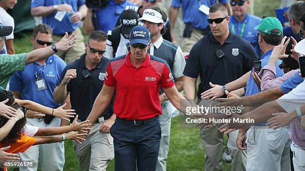 Henrik Stenson of Sweden and Bubba Watson of the United States walk to the ninth hole during the third round of The Barclays at Plainfield Country...