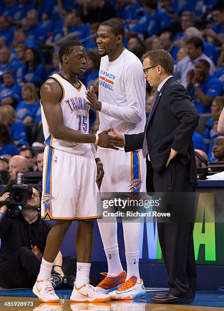 Reggie Jackson, Kevin Durant and Scott Brooks of the Oklahoma City Thunder talk during the Memphis Grizzlies in Game One of the Western Conference...