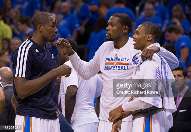 Serge Ibaka, Kevin Durant and Russell Westbrook of the Oklahoma City Thunder talk during the Memphis Grizzlies in Game One of the Western Conference...