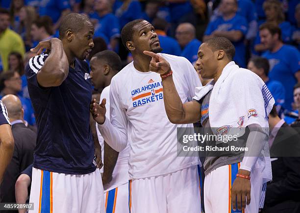 Serge Ibaka, Kevin Durant and Russell Westbrook of the Oklahoma City Thunder talk during the Memphis Grizzlies in Game One of the Western Conference...