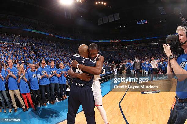 Derek Fisher and Kevin Durant of the Oklahoma City Thunder hug before the game against the Memphis Grizzlies in Game One of the Western Conference...