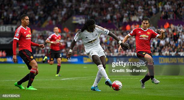 Swansea striker Bafetimbi Gomis shoots to score the second Swansea goal during the Barclays Premier League match between Swansea City and Manchester...