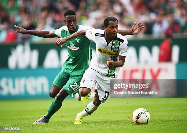 Ulisses Garcia of Bremen is challenged by Raffael of Gladbach during the Bundesliga match between Werder Bremen and Borussia Moenchengladbach at...