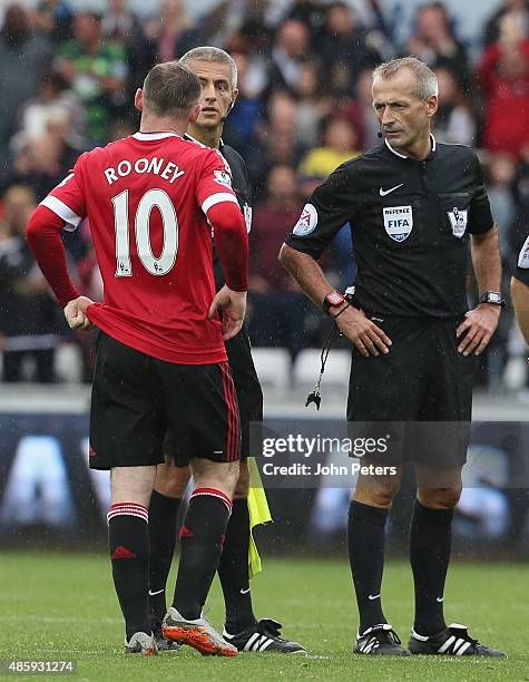 Wayne Rooney of Manchester United complains to referee Martin Atkinson during the Barclays Premier League match between Swansea City and Manchester...