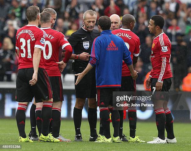 Juan Mata of Manchester United complains to referee Martin Atkinson after the Barclays Premier League match between Swansea City and Manchester...