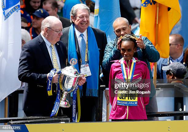 Rita Jeptoo of Kenya celebrates with the trophy after winning the 118th Boston Marathon on April 21, 2014 in Boston, Massachusetts.