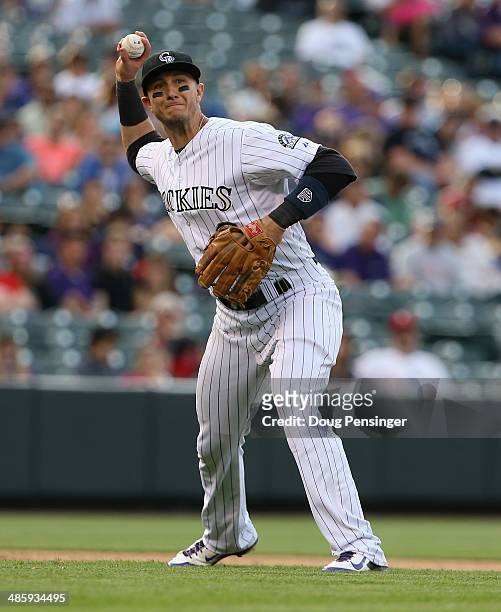 Shortstop Troy Tulowitzki of the Colorado Rockies throws out a runner against the Philadelphia Phillies at Coors Field on April 20, 2014 in Denver,...