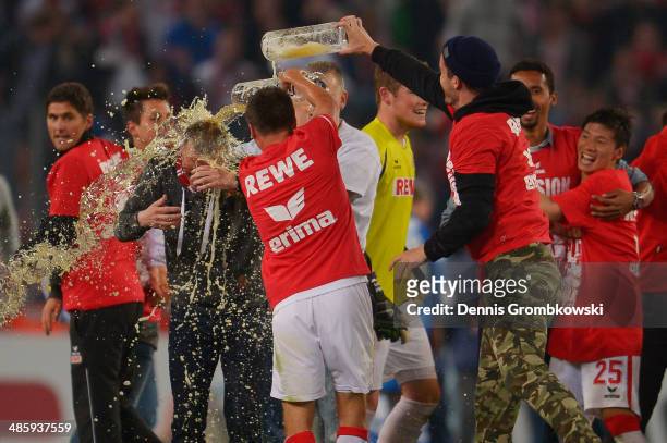 Head coach Peter Stoeger of 1. FC Koeln celebrates with his team during the Second Bundesliga match between 1. FC Koeln and VfL Bochum at...