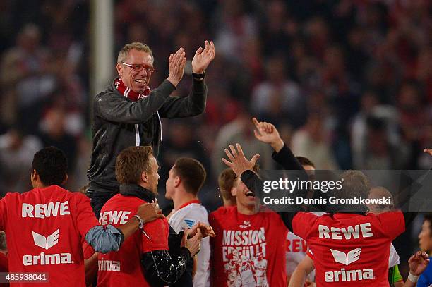 Head coach Peter Stoeger of 1. FC Koeln celebrates with his team during the Second Bundesliga match between 1. FC Koeln and VfL Bochum at...