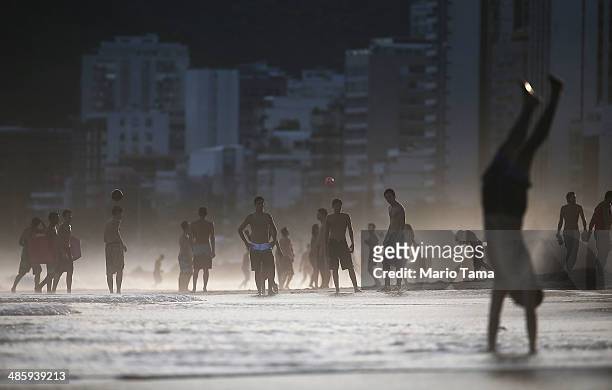 Brazilians play altinha , a spin-off of soccer played on the beach, as others gather on Ipanema Beach on April 21, 2014 in Rio de Janeiro, Brazil....