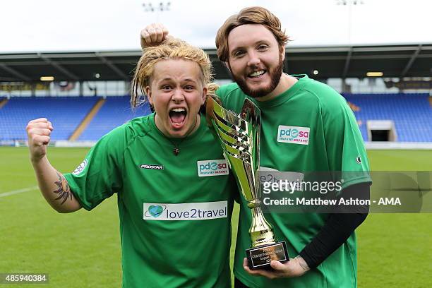 Musicians Luke Friend and James Arthur celebrate with the trophy after a charity football match in aid of PDSA at Greenhous Meadow, home of...