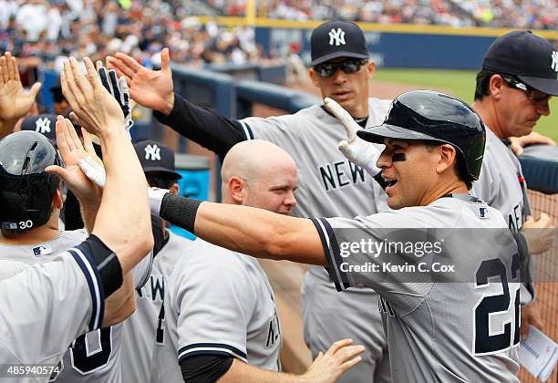 Jacoby Ellsbury of the New York Yankees celebrates after hitting a three-run homer in the second inning against the Atlanta Braves at Turner Field on...