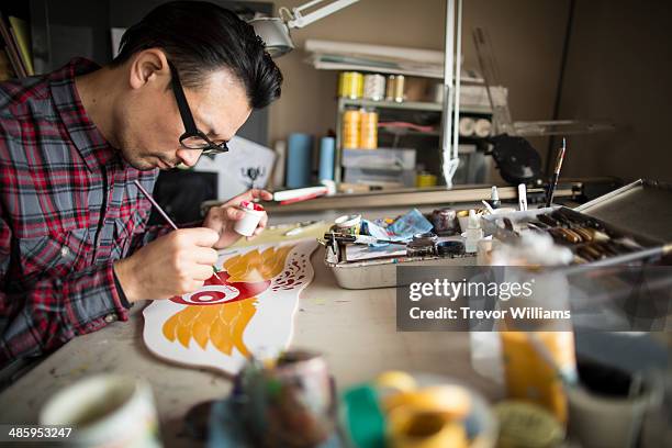 an artist working with a paint brush - japanese art stock pictures, royalty-free photos & images