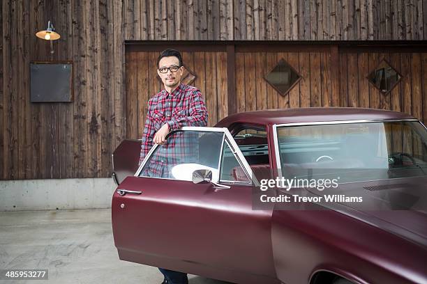 a man standing with his classic car - oldtimerauto fotografías e imágenes de stock