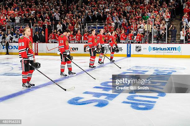 The starting line-up for the Chicago Blackhawks, Patrick Kane, Jonathan Toews, Sheldon Brookbank, Bryan Bickell and Duncan Keith, stand for the...