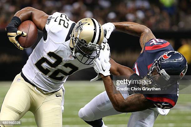 Spiller of the New Orleans Saints is tackled by Eddie Pleasant of the Houston Texans at the Mercedes-Benz Superdome on August 30, 2015 in New...